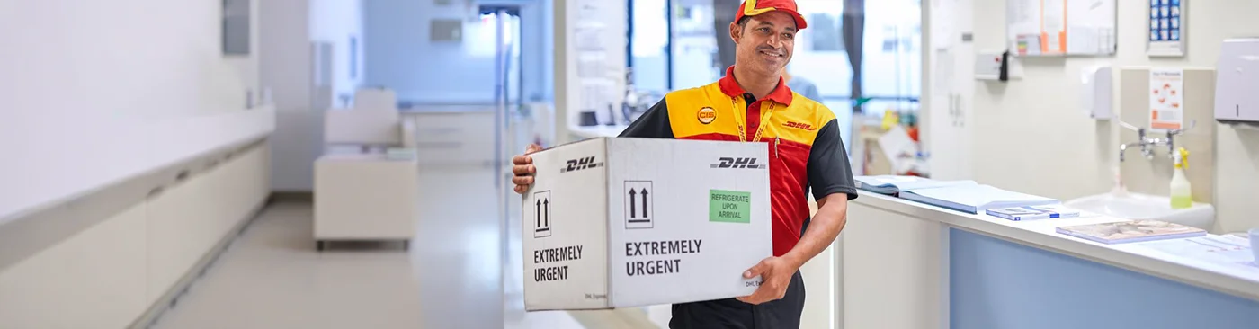 DHL Medical Express' validated and fit-for-purpose packaging in a laboratory with an assistant checking data