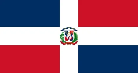 Flag of the Dominican Republic with a central white cross dividing the flag into four rectangles: blue at the top left and bottom right, and red at the top right and bottom left, featuring the national coat of arms at the center of the cross.
