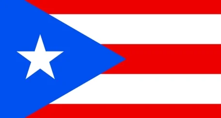 Flag of Puerto Rico with five alternating red and white horizontal stripes, a blue triangle on the left, and a white star in the center of the triangle.