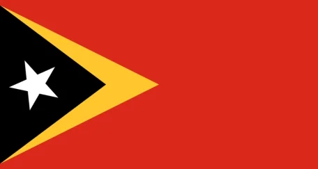 Flag of East Timor: A red field with a black triangle on the left, featuring a white star in the triangle and a yellow triangle extending from the right