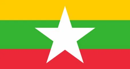 The flag of Myanmar features three horizontal stripes: yellow on the top, green in the middle, and red on the bottom. A large white five-pointed star is centered on the flag.