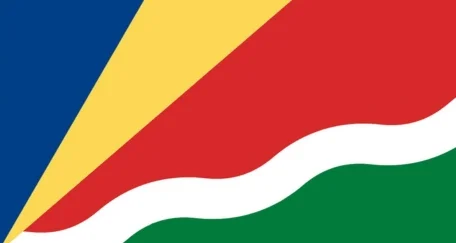The flag of Seychelles features five oblique stripes radiating from the bottom left corner in blue, yellow, red, white, and green.